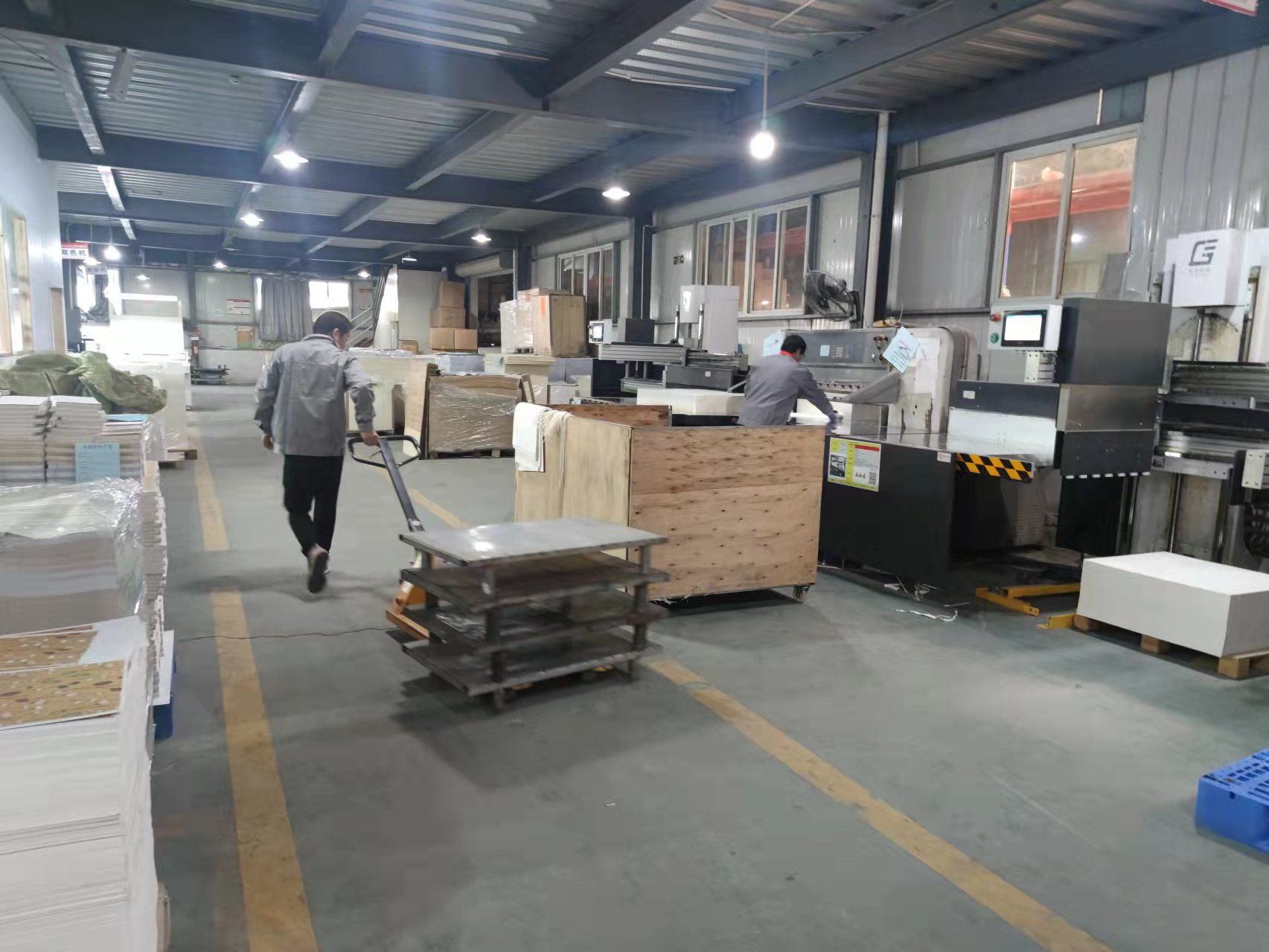 QIANYOU pressroom with intelligent paper-cutting machinery and stacked print sheets